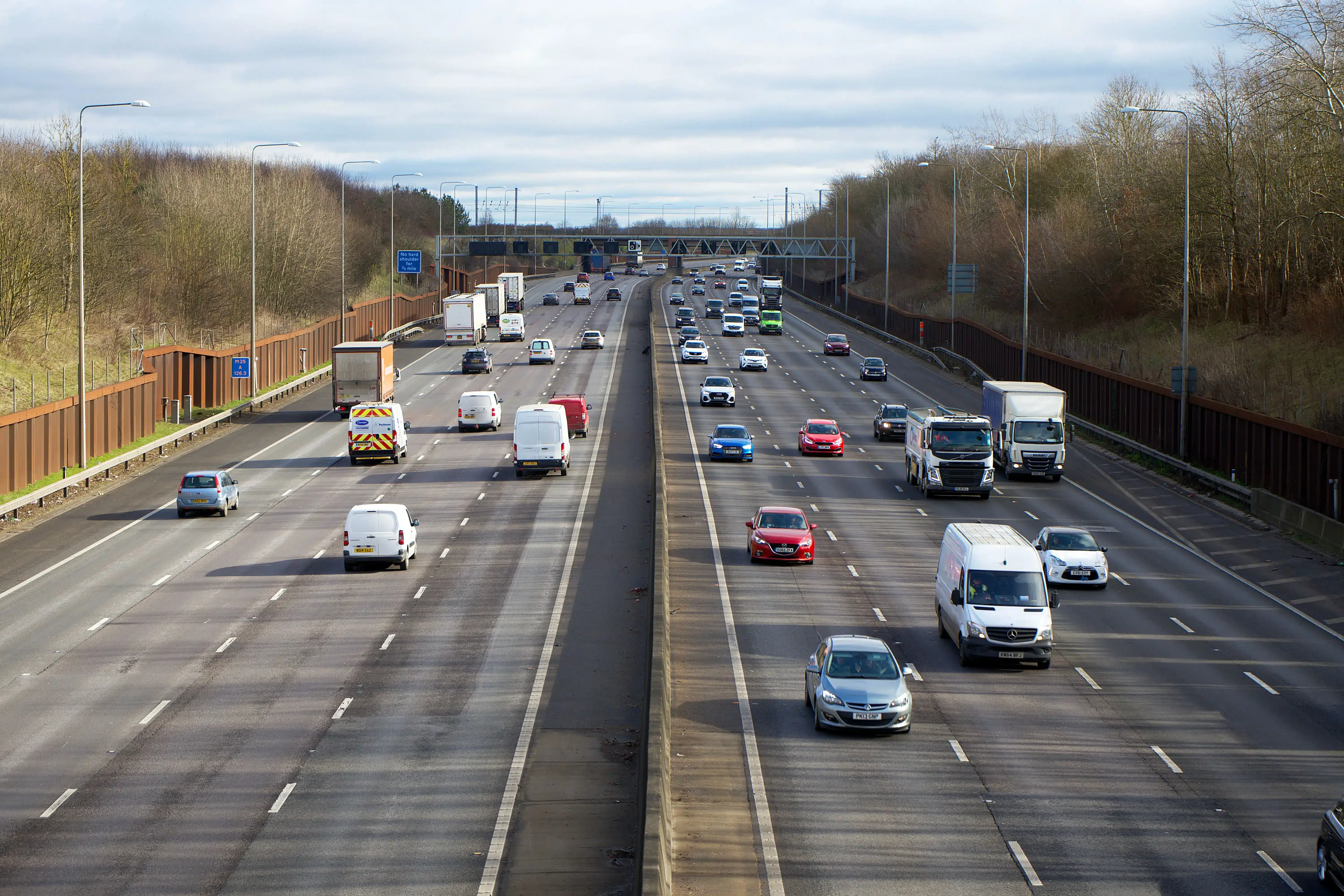 Trucks and cars on busy road